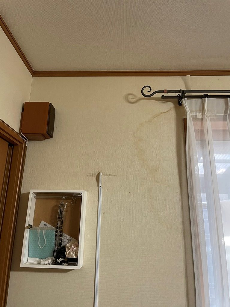 雨染みが広がった窓脇の壁